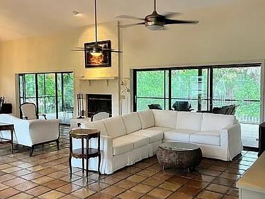 A living room features a white sectional sofa, a fireplace, and large sliding glass doors — 881 PINTO CIRCLE, NOKOMIS, FL