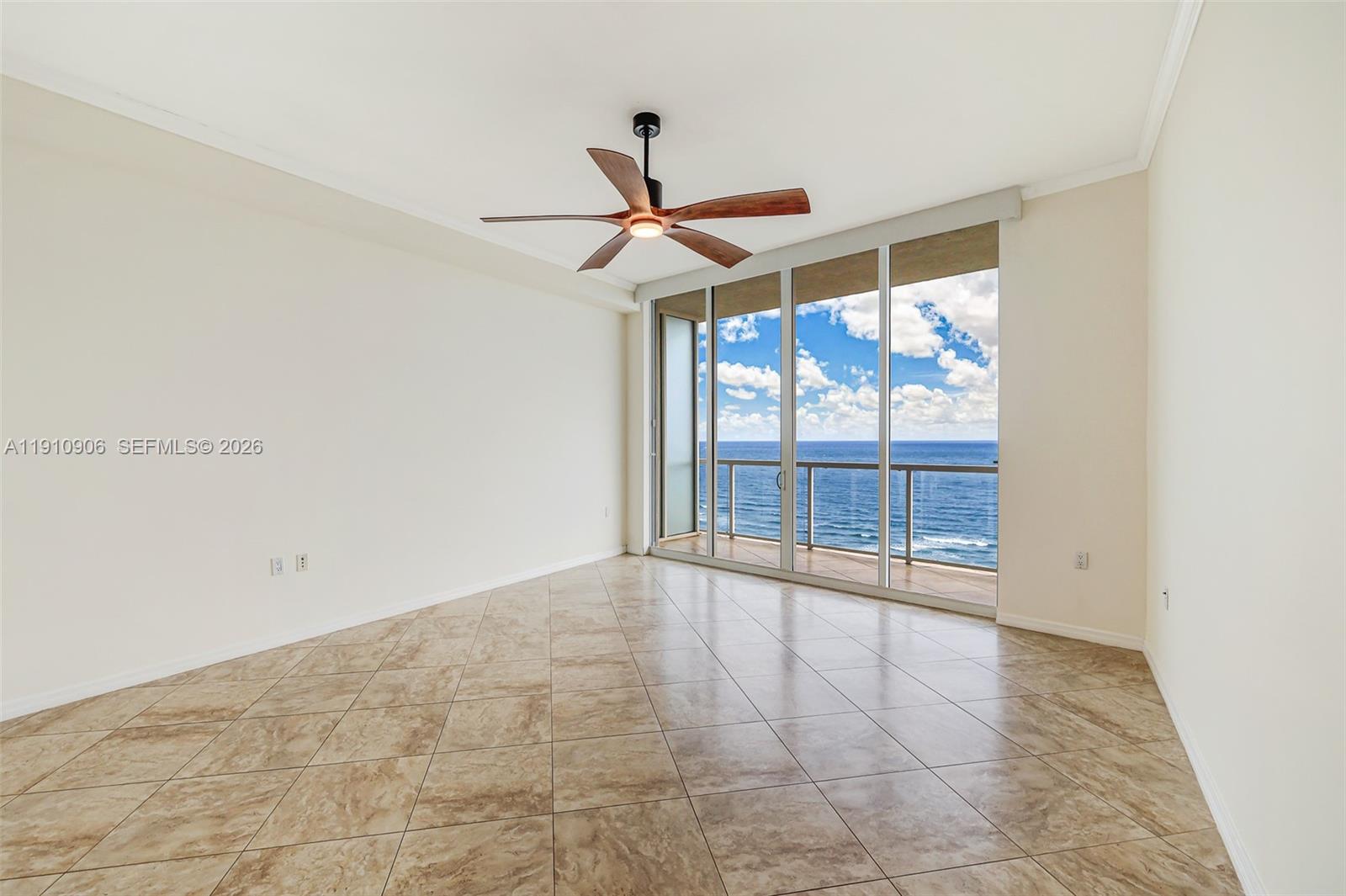 An empty room with tiled floors, a ceiling fan, and floor-to-ceiling windows overlooking the ocean — 704 N Ocean Blvd # 1001, Pompano Beach FL 33062, POMPANO BEACH, FL