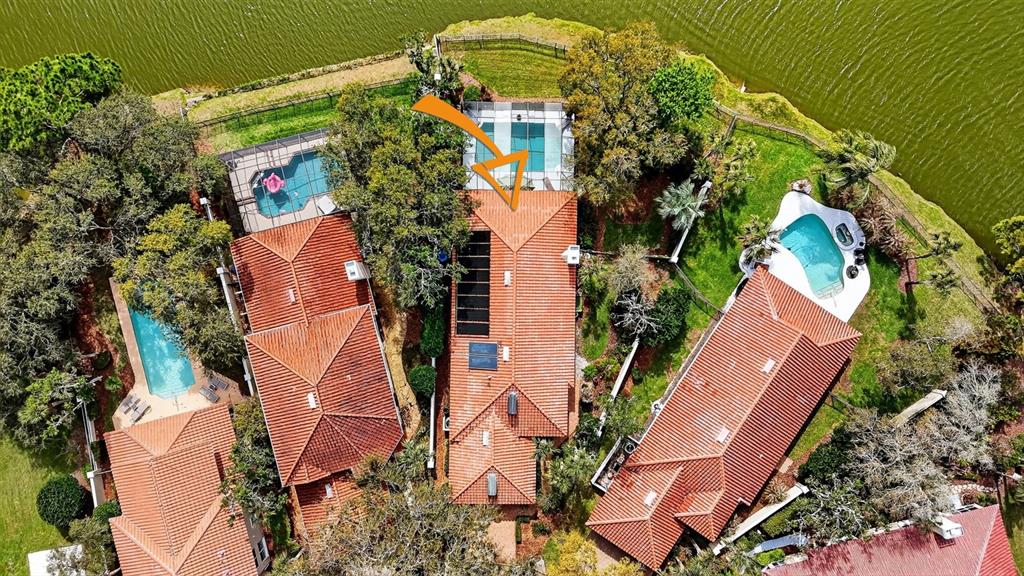 A covered patio features a dining set, lounge furniture, and a screened-in swimming pool — 11 LAGUNA COURT, PALM COAST, FL