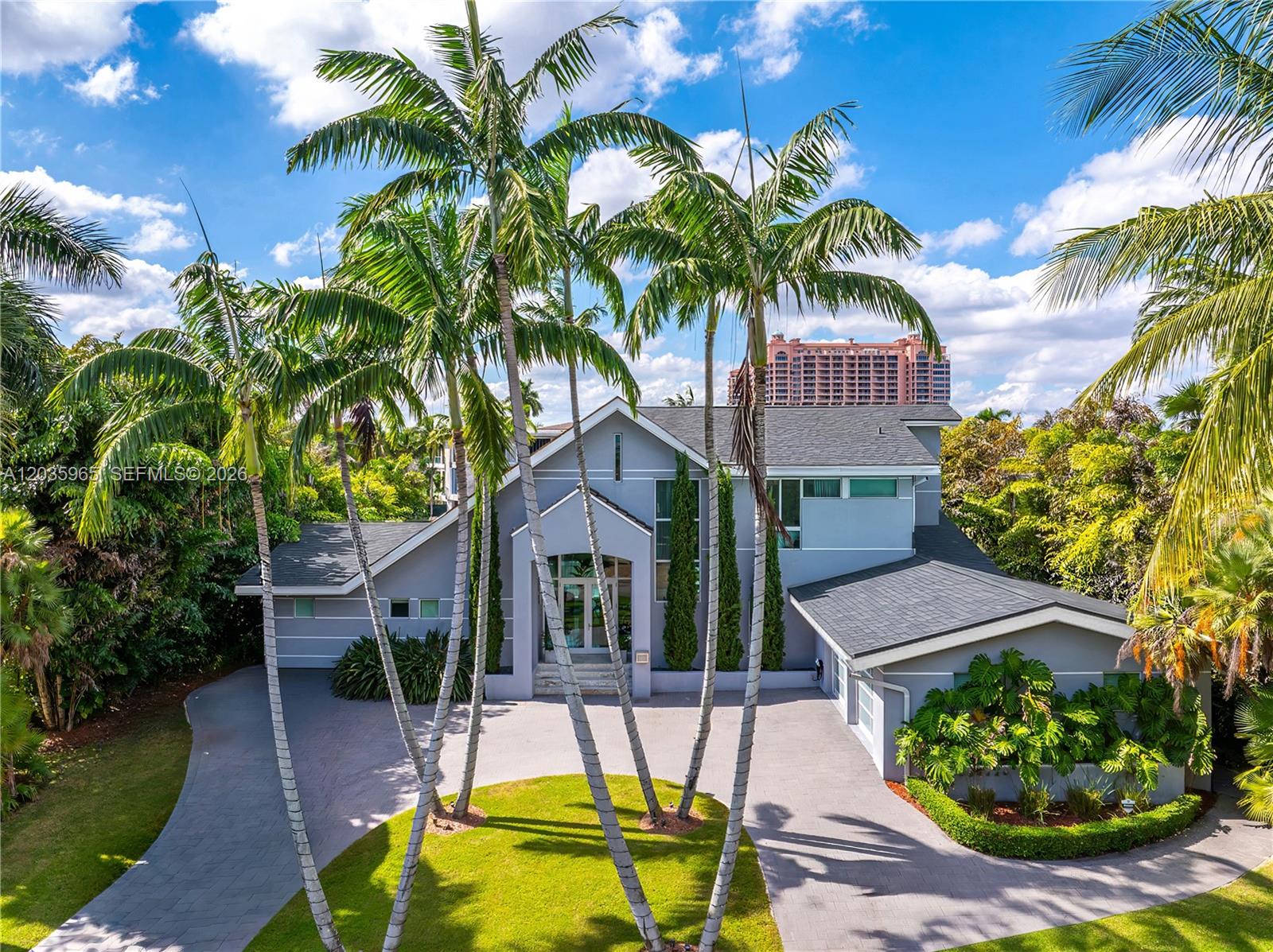 An aerial view of a two-story gray house with a circular driveway and palm trees — 6944 Sunrise Ter, Coral Gables FL 33133, CORAL GABLES, FL
