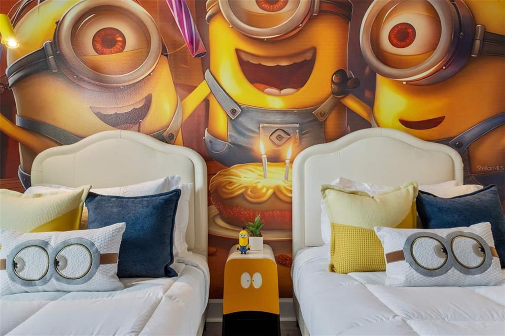 A bedroom features two twin beds with Minion-themed bedding and a large Minion wall mural — 4041 SONOMA BOULEVARD, KISSIMMEE, FL