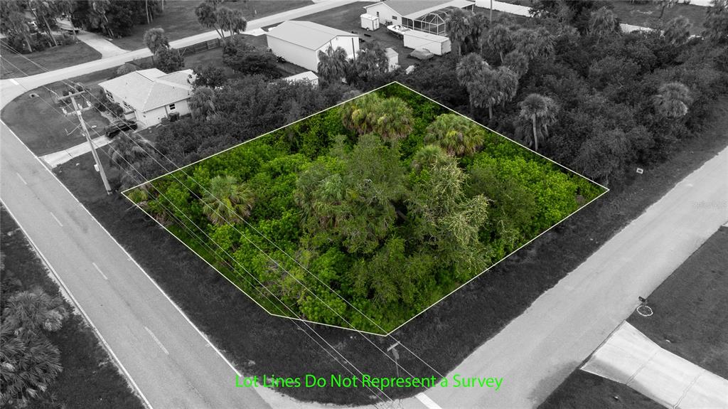 An aerial view shows a vacant, tree-covered lot outlined in green between two paved roads — 18390 OHARA DRIVE, PORT CHARLOTTE, FL