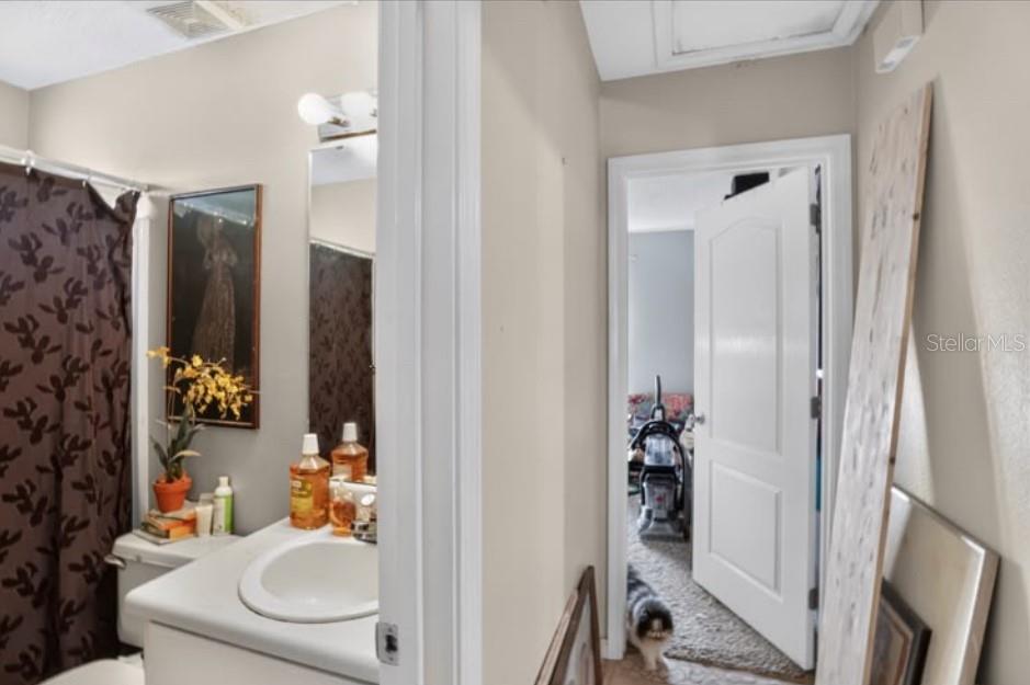 A bathroom vanity and shower curtain are visible next to a doorway leading to a bedroom — 4374 MARILYN COURT, GULF BREEZE, FL