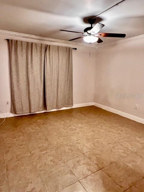 An empty room features beige tile flooring, a ceiling fan, and curtains covering a window — 942 LAKE DESTINY ROAD UNIT A, ALTAMONTE SPRINGS, FL