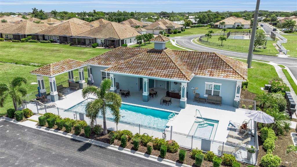 An aerial view shows a community clubhouse with a swimming pool and a hot tub — 7004 VISTA BELLA DRIVE, BRADENTON, FL