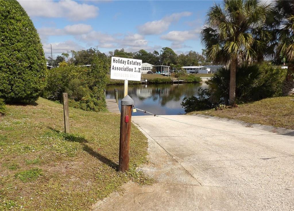 A concrete boat ramp leads to a canal with a private access sign — 1422 FLAMINGO DRIVE, ENGLEWOOD, FL