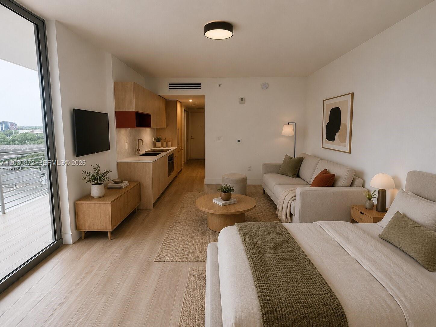 This studio apartment features a kitchenette, a living area with a sofa, and a bed — 90 NE 32nd St # 615, Miami FL 33127, MIAMI, FL
