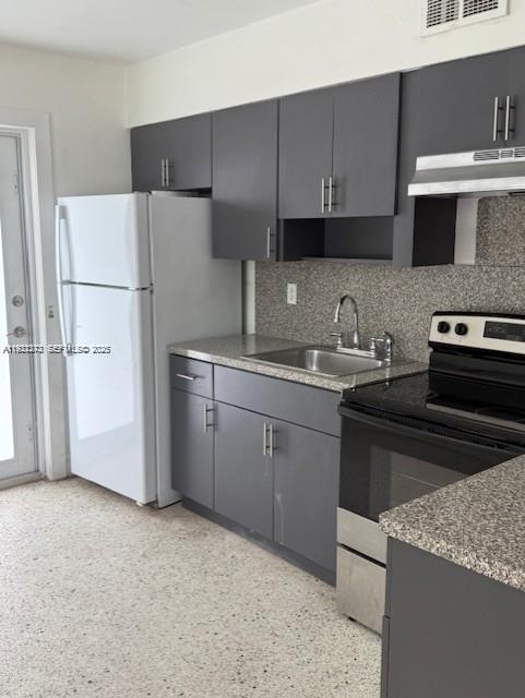 A kitchen features dark gray cabinets, stainless steel appliances, and a speckled countertop — 67 NW 34th St, Miami FL 33127, MIAMI, FL