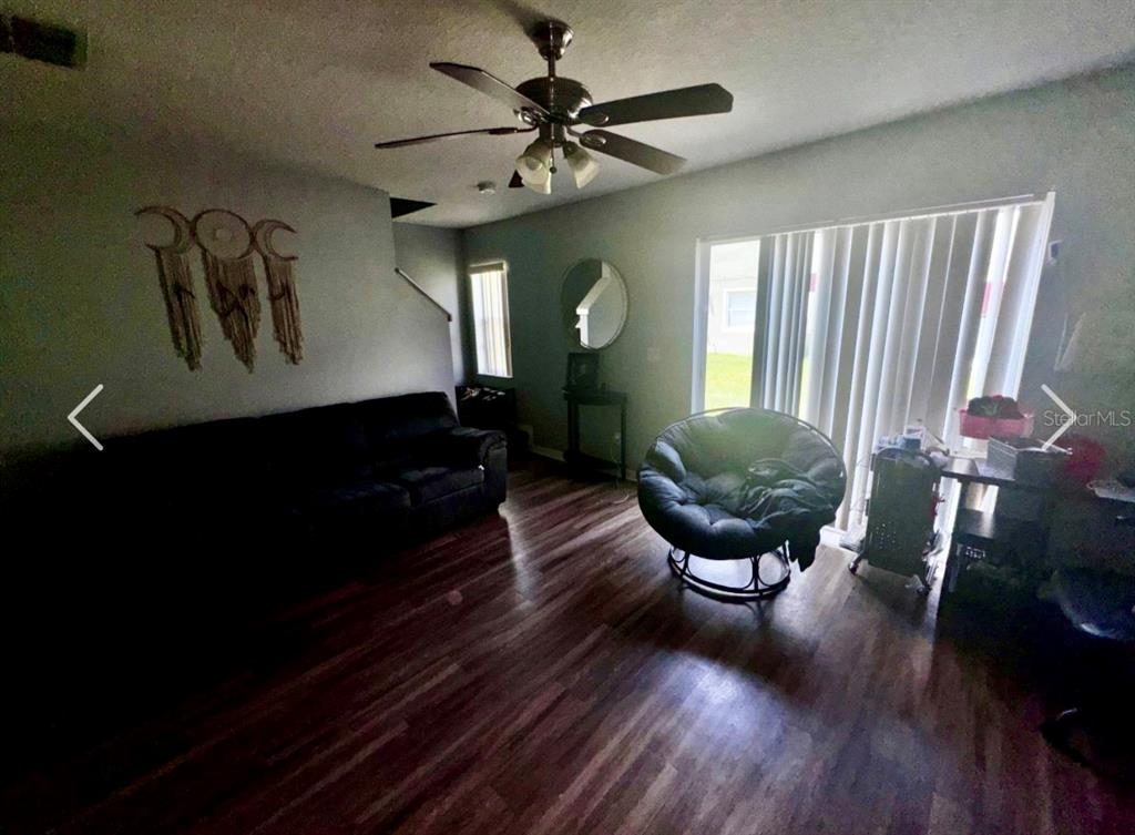 A kitchen with wood cabinets, white appliances, laminate countertops, and light-colored tile flooring — 533 CRESTING OAK CIRCLE UNIT 79, ORLANDO, FL