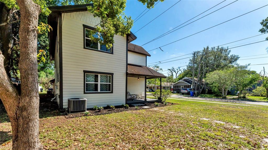 A two-story house with white siding, dark trim, and a covered front porch — 728 W BELMAR STREET, LAKELAND, FL