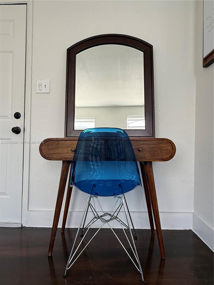 A wooden vanity with a mirror and a blue transparent chair sit against a wall — 723 2nd St # 8, Miami Beach FL 33139, MIAMI BEACH, FL