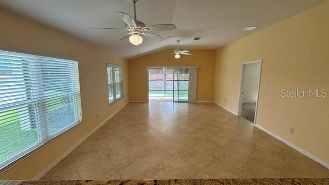 A beige single-story house features a two-car garage, a covered entryway, and landscaped front beds — 2877 FEUSTEL AVENUE, THE VILLAGES, FL