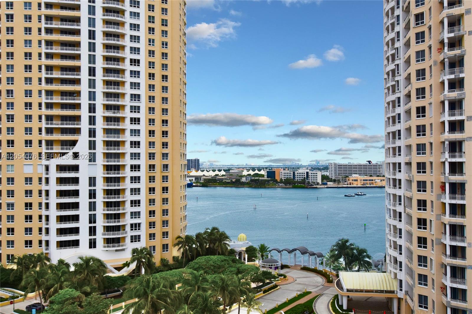 An elevated view of a waterway between two tall residential towers with palm trees below — 540 Brickell Key Dr # 1414, Miami FL 33131, MIAMI, FL