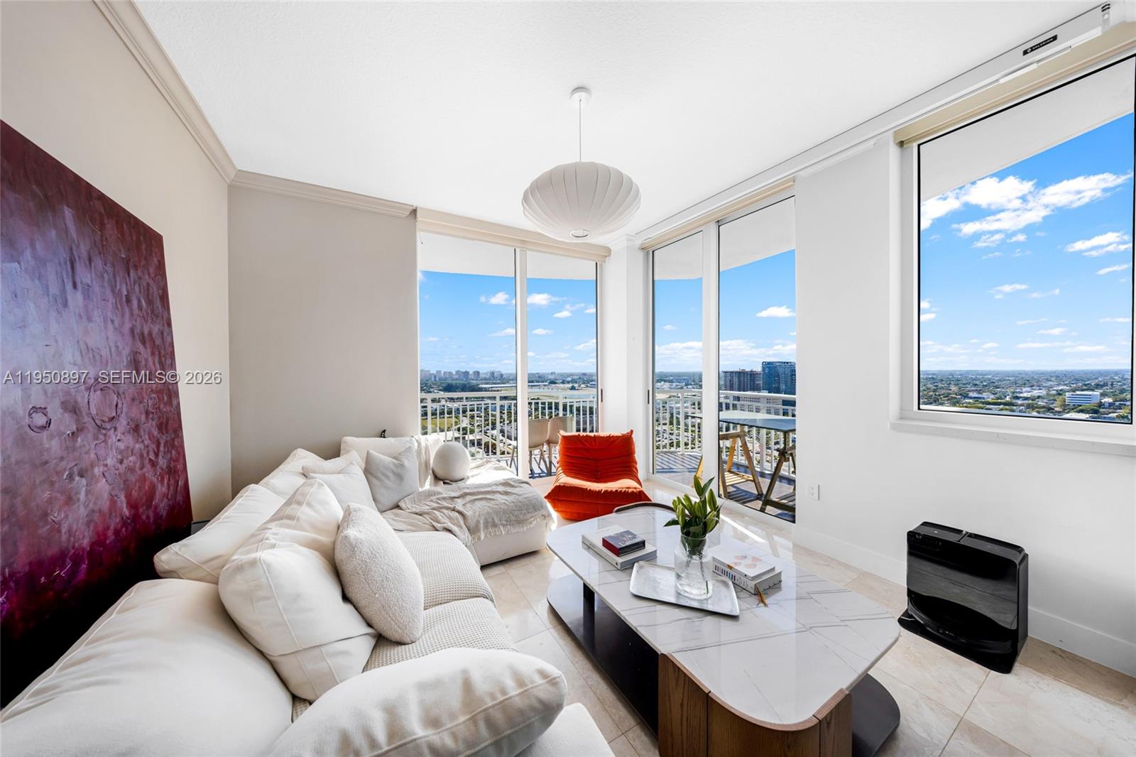A modern living room features a white sectional sofa, marble coffee table, and floor-to-ceiling windows — 1745 E Hallandale Beach Blvd # 2407W, Hallandale Beach FL 33009, HALLANDALE BEACH, FL
