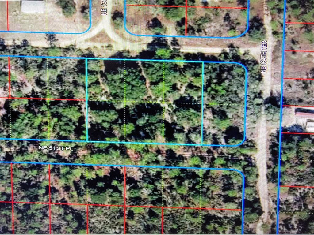 An aerial map view shows a rectangular plot of land highlighted in blue — 0 NE 52ND STREET, WILLISTON, FL
