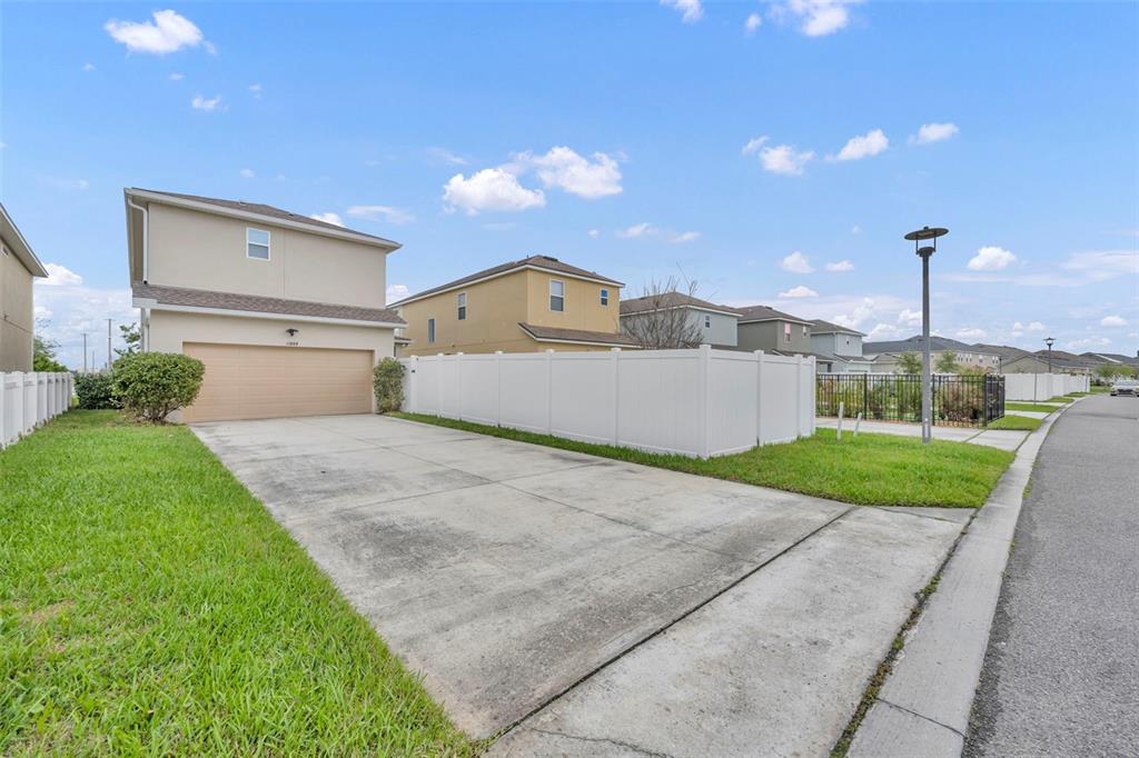 The exterior entrance features a red front door with a sidelight under a covered porch — 11844 FOUNDERS STREET, ORLANDO, FL