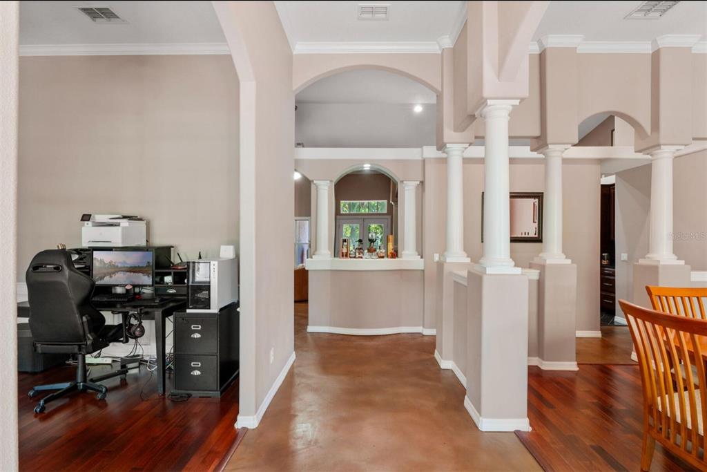 A home office area with a desk and computer sits adjacent to a columned entryway — 2304 INDIAN MOUND TRAIL, KISSIMMEE, FL