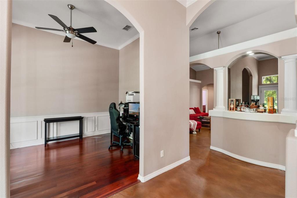 An office space with hardwood floors and a ceiling fan sits beside a wet bar — 2304 INDIAN MOUND TRAIL, KISSIMMEE, FL