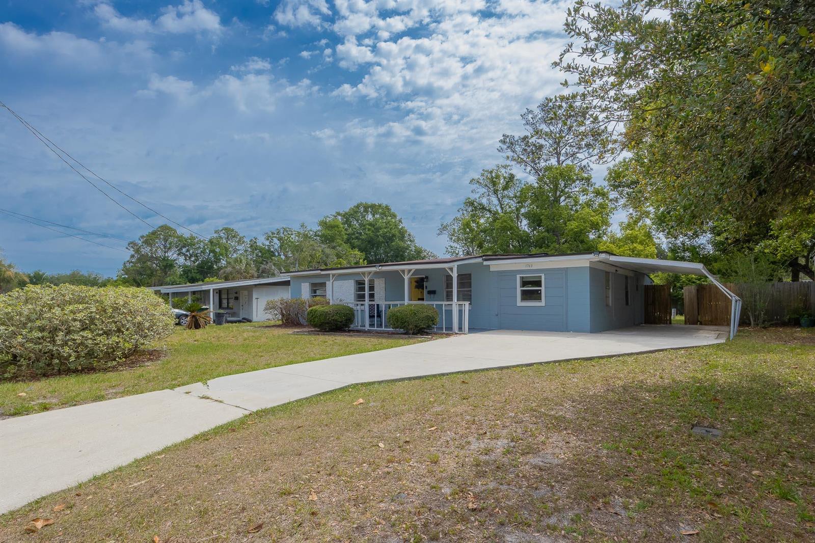 A single-story light blue house with a concrete driveway and a covered carport — 1763 Lawson Road, Jacksonville FL 32246, JACKSONVILLE, FL