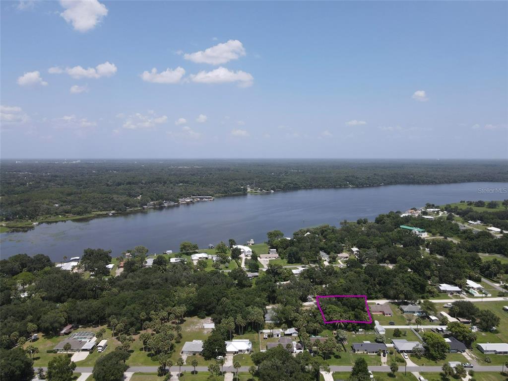 An aerial view shows a rectangular plot of land outlined in purple near a lake — 1622 PALM STREET, DELAND, FL