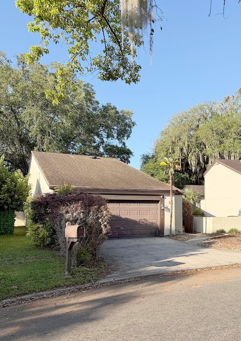 A single-story house with a brown garage door, a concrete driveway, and surrounding trees — 7962 Linkside Drive, Jacksonville FL 32256, JACKSONVILLE, FL