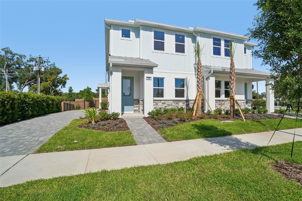 A two-story house with white siding, stone accents, and a blue front door — 610 SILVER STREAM COURT, BRANDON, FL