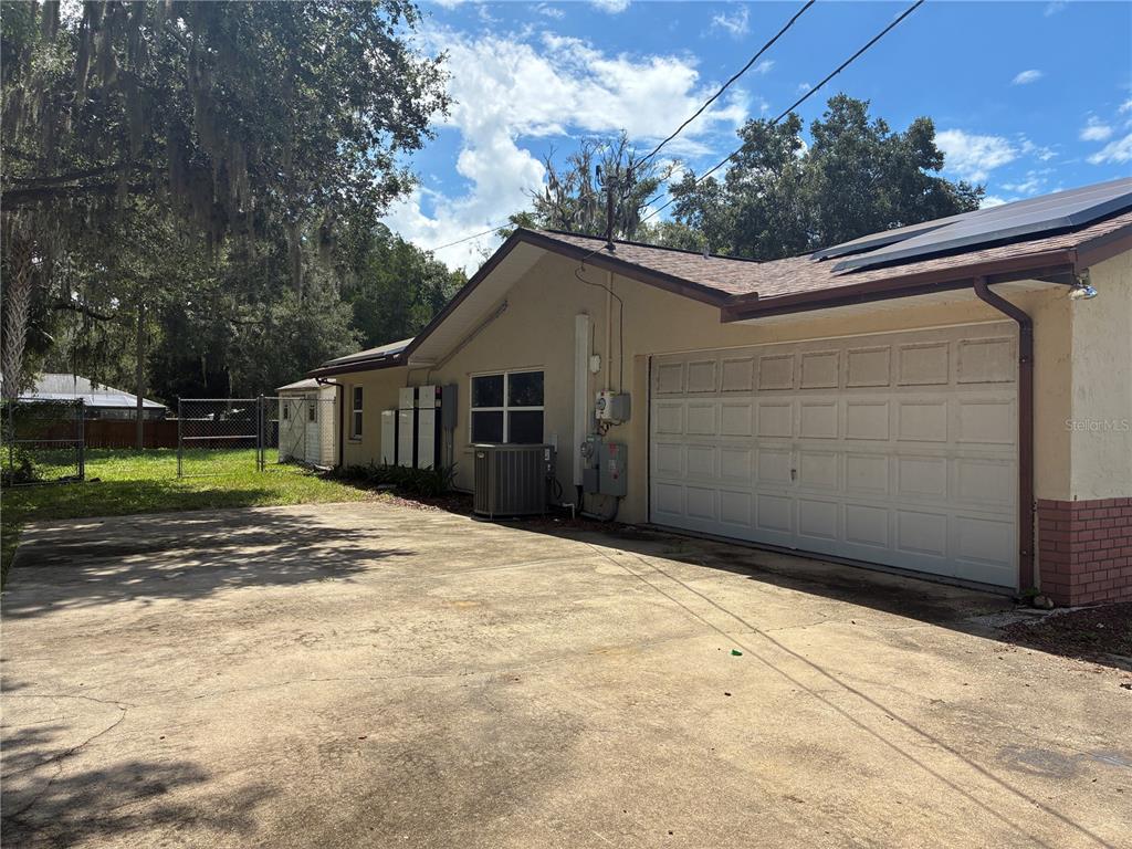The exterior of a house features a concrete driveway, a garage, and solar panels — 6383 N JADE TERRACE, CRYSTAL RIVER, FL
