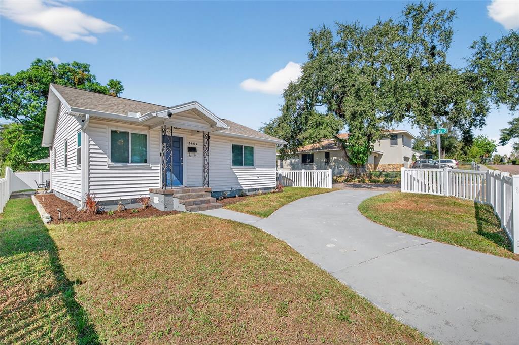 An aerial view shows a single-story house with a grey roof and a fenced yard — 2401 19TH STREET S, ST PETERSBURG, FL