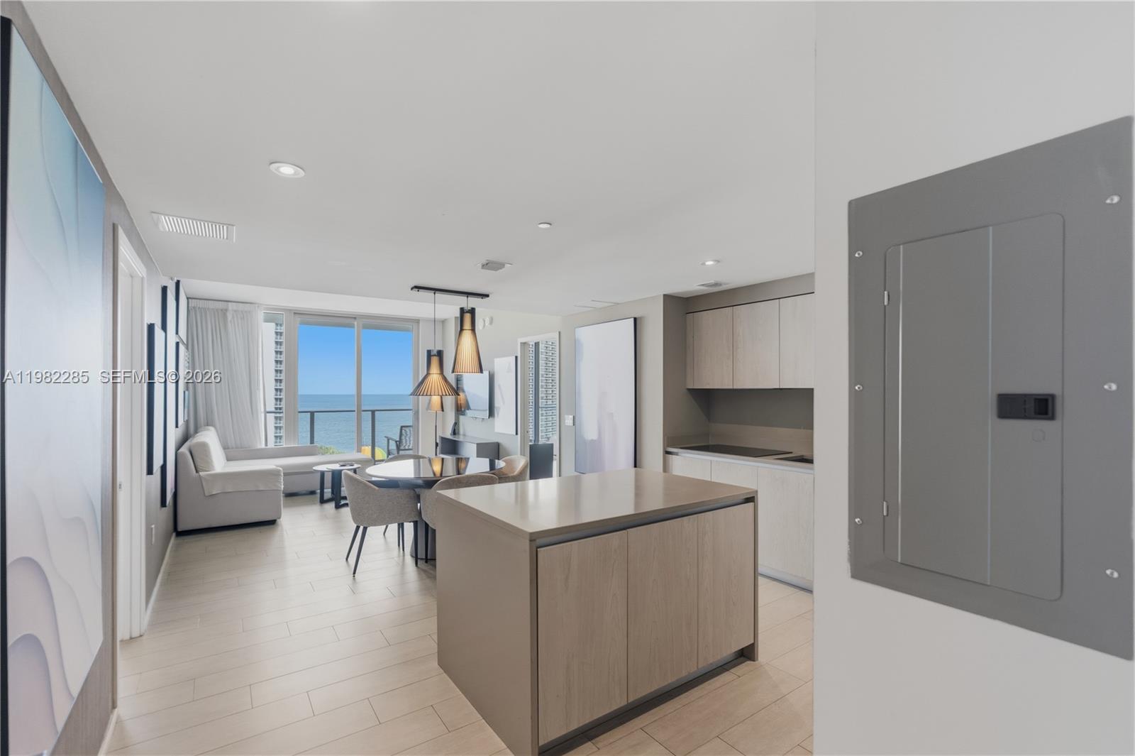 This open-concept living area features a kitchen island, dining space, and ocean views — 4010 S Ocean Dr # R2005, Hollywood FL 33019, HOLLYWOOD, FL