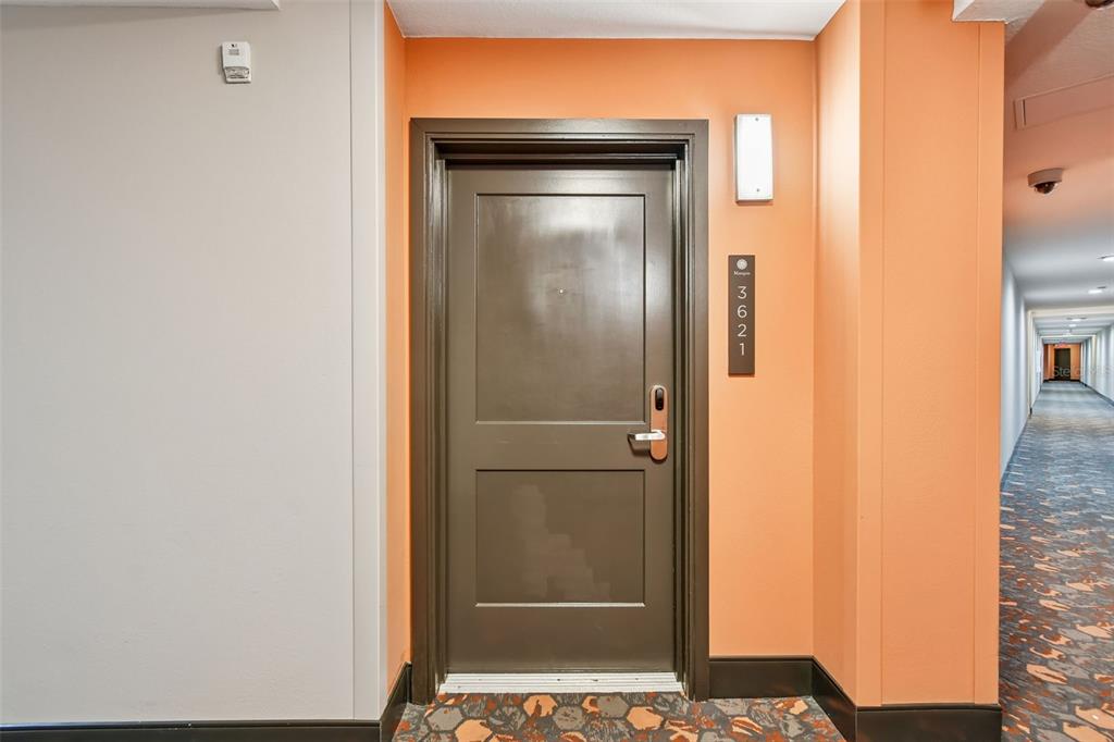 A dark brown door with the number 3621 is set in an orange wall — 14501 GROVE RESORT AVE UNIT 3621, WINTER GARDEN, FL