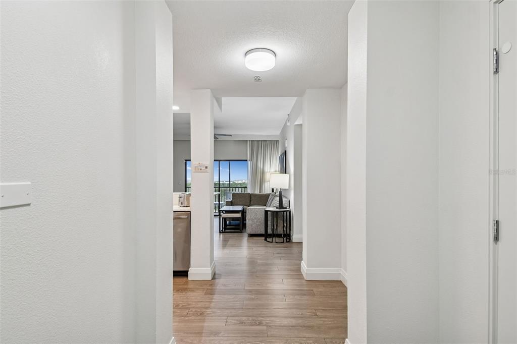 A view from a hallway looking into a living area with wood-look flooring — 14501 GROVE RESORT AVE UNIT 3621, WINTER GARDEN, FL