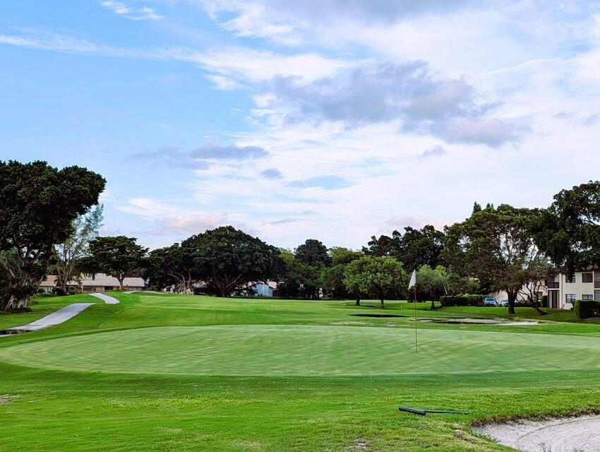 A view of a golf course putting green with a flag and surrounding trees — 21362 Juego Circle # 33f, Boca Raton FL 33433, BOCA RATON, FL