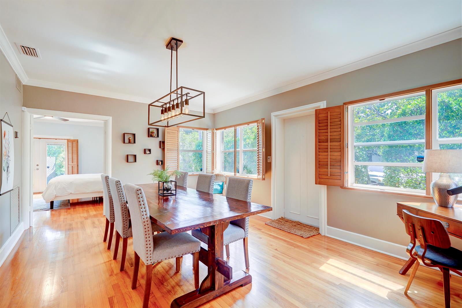 A dining room with a wooden table, gray chairs, and a desk near a window — 411 26th Street, West Palm Beach FL 33407, WEST PALM BEACH, FL