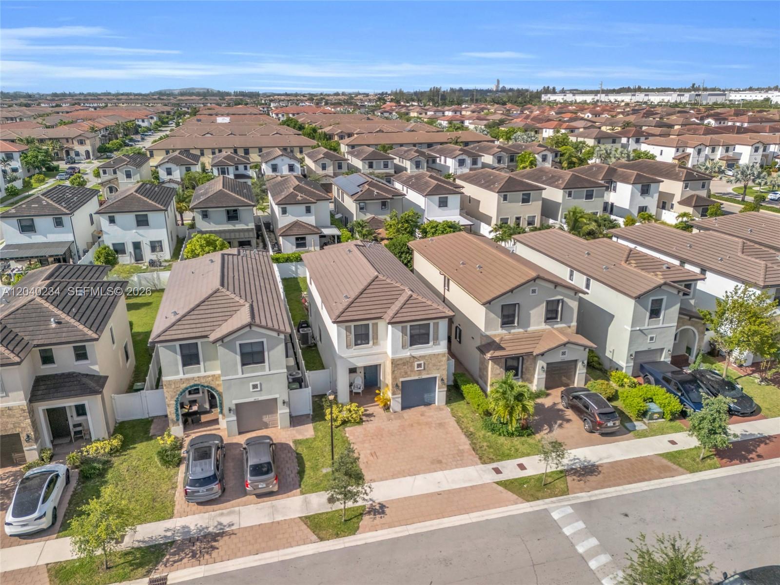 An aerial view shows a suburban neighborhood with rows of two-story houses and paved driveways — 3416 W 109th Pl, Hialeah FL 33018, HIALEAH, FL