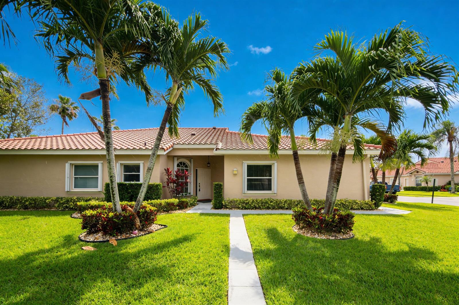 A single-story beige house with a tile roof, palm trees, and a front walkway — 6419 Long Key Lane, Boynton Beach FL 33472, BOYNTON BEACH, FL