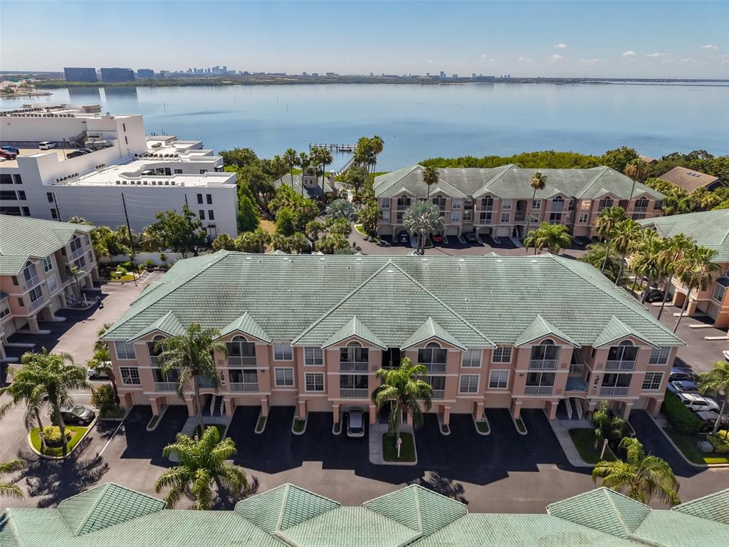 An aerial view of a multi-story apartment complex with green tile roofs near water — 3312 BAY CLUB CIRCLE UNIT 3312, TAMPA, FL