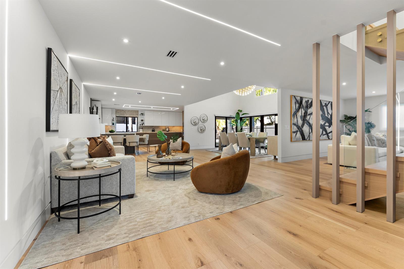 An open-concept living area features light wood floors, modern recessed lighting, and neutral furniture — 1690 S Ocean Boulevard, Delray Beach FL 33483, DELRAY BEACH, FL