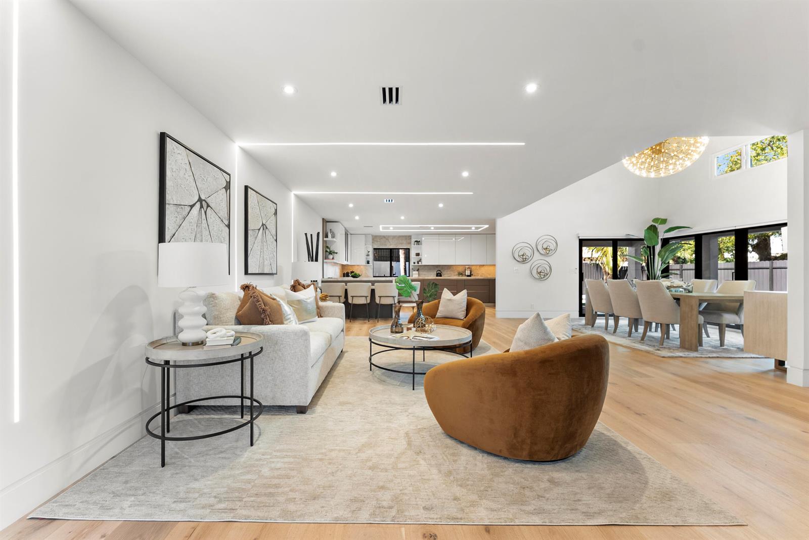An open-concept living and dining area features white walls, light wood floors, and modern furniture — 1690 S Ocean Boulevard, Delray Beach FL 33483, DELRAY BEACH, FL