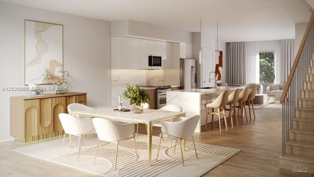 This rendering shows an open-concept kitchen and dining area with modern furniture and wood flooring — MIAMI, FL