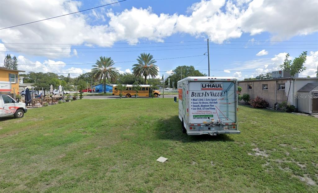 A U-Haul trailer sits on a grassy lot with a school bus in the background — 101 CLEARWATER-LARGO ROAD, LARGO, FL