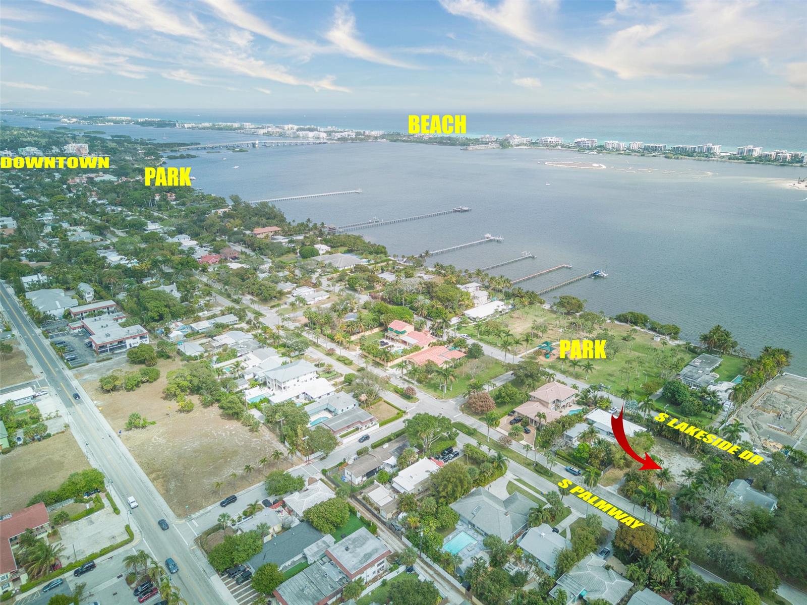 This aerial view shows a coastal residential neighborhood with a vacant lot near the water — 1118 S Palmway, FL 33460, FL