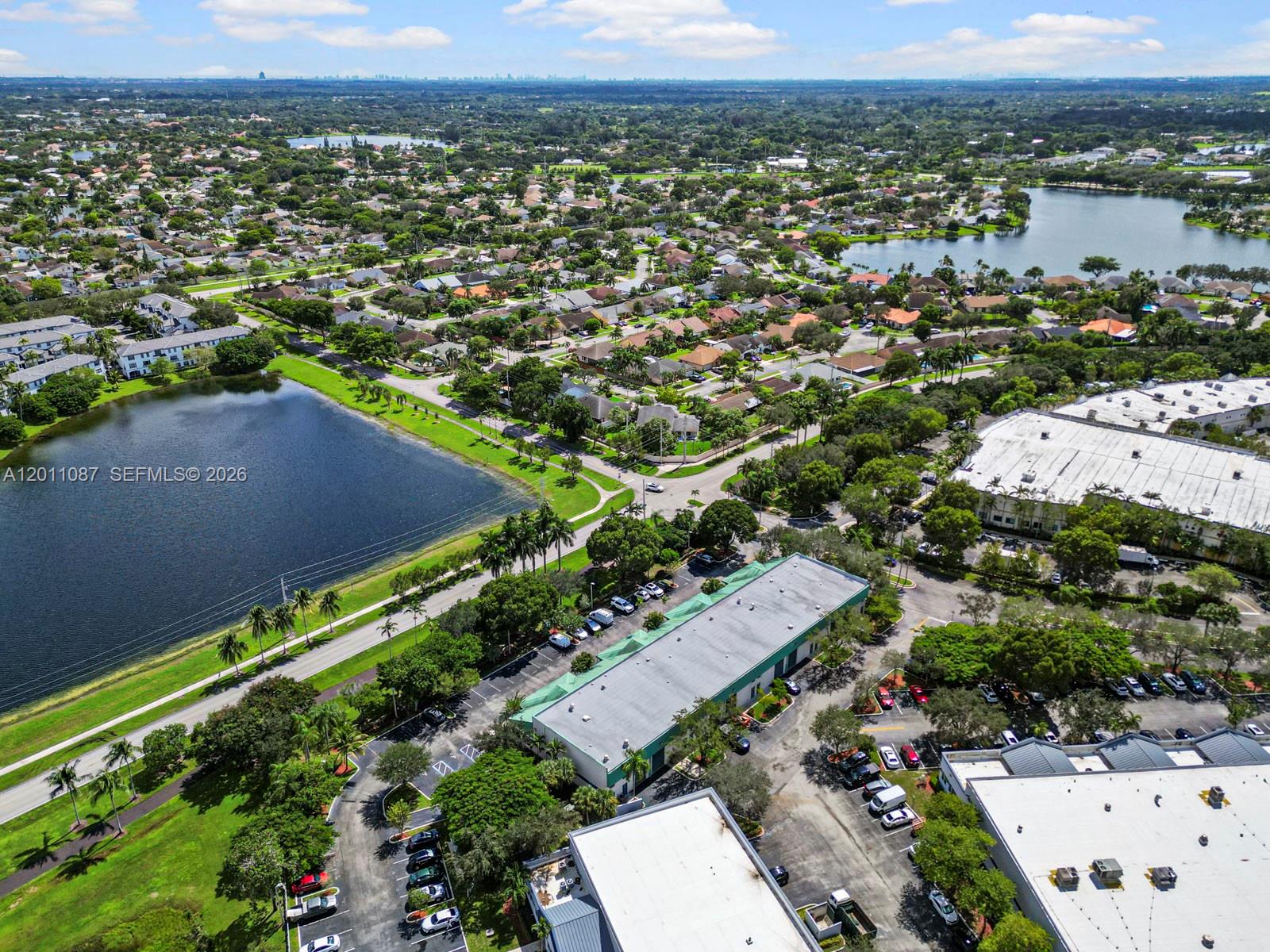 An aerial view shows a commercial building complex surrounded by parking lots and residential neighborhoods — 735 Shotgun Rd, Sunrise FL 33326, SUNRISE, FL