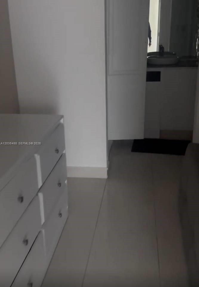 A white dresser stands in a room with light-colored tile flooring and an open doorway — 23000 ciudad las canas # 0, FL