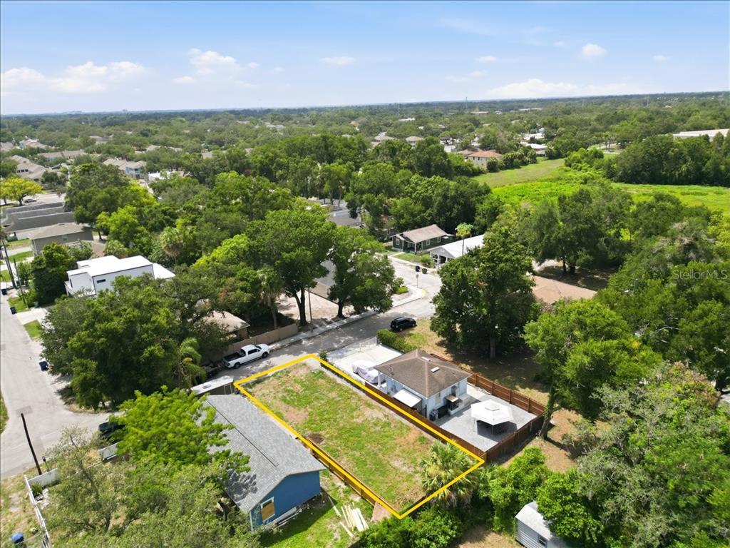 An aerial view shows a vacant rectangular lot situated between two houses in a neighborhood — 3107 N 24TH STREET, TAMPA, FL