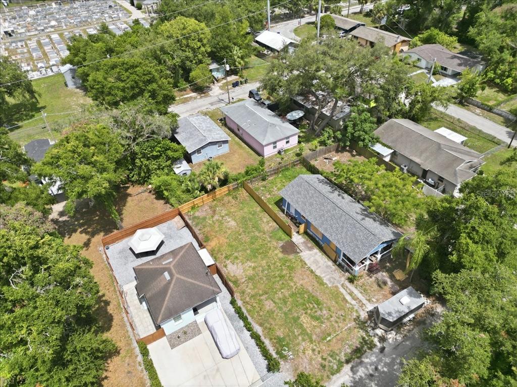 An aerial view shows two adjacent residential properties with houses, fenced yards, and surrounding trees — 3107 N 24TH STREET, TAMPA, FL