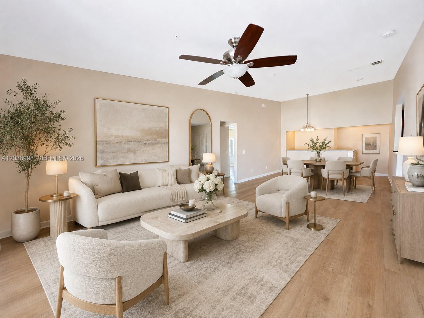 A neutral-toned living and dining area features light wood flooring, a ceiling fan, and furniture — 4026 MEANDER PL # 208, Rockledge FL 32955, ROCKLEDGE, FL
