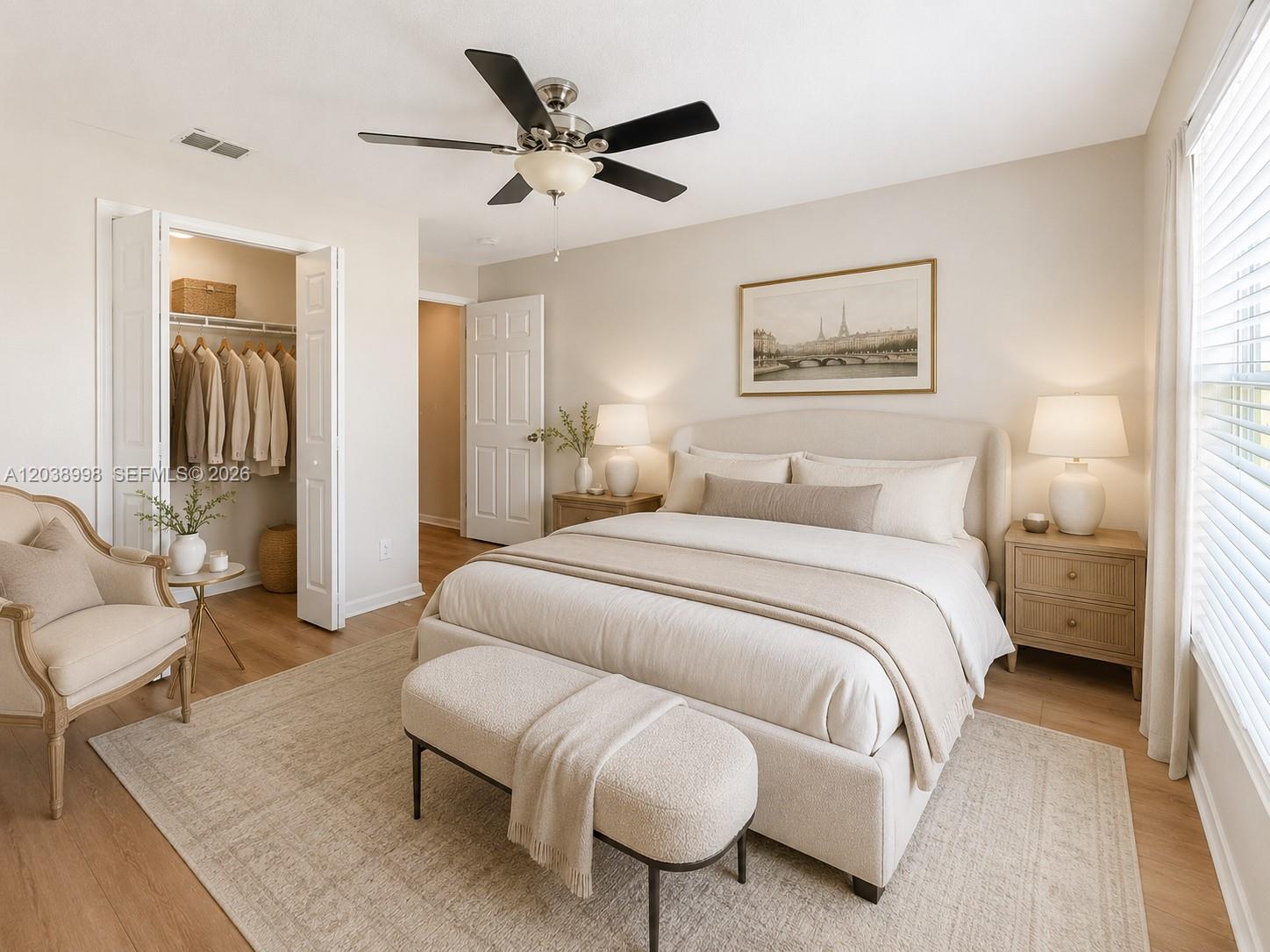 A bedroom features a bed, a bench, a closet, and a chair on wood flooring — 4026 MEANDER PL # 208, Rockledge FL 32955, ROCKLEDGE, FL