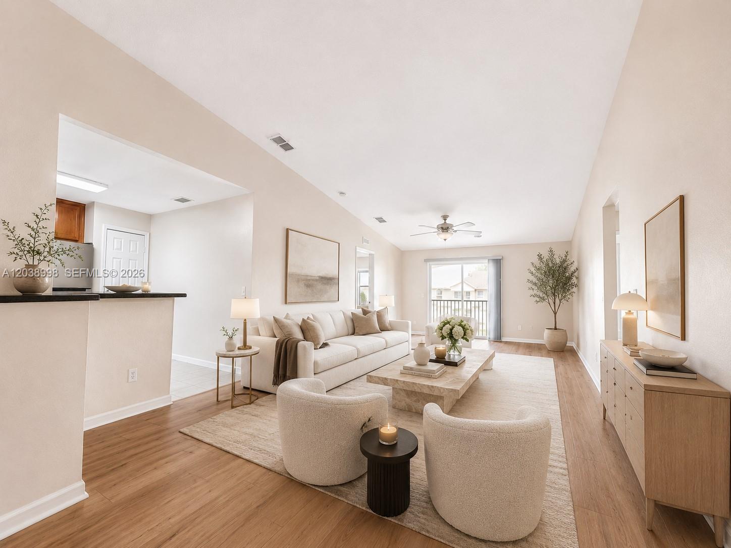 A bright living room features a beige sofa, two armchairs, and light wood flooring — 4026 MEANDER PL # 208, Rockledge FL 32955, ROCKLEDGE, FL