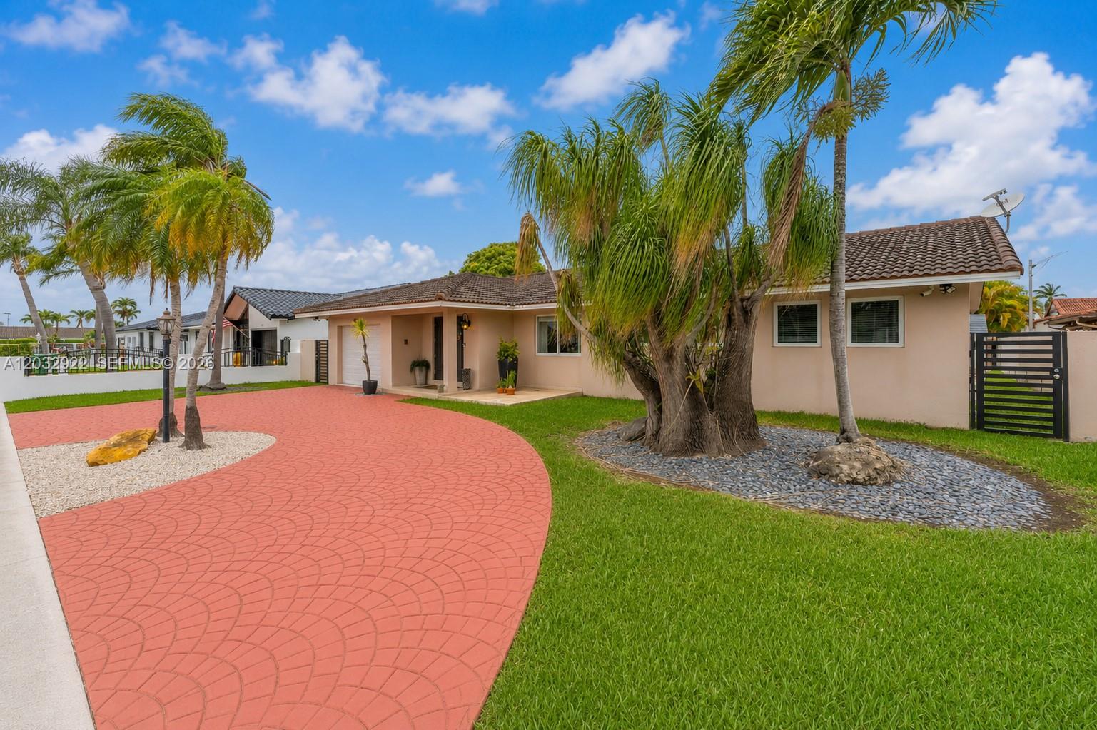 A single-story house with a red stamped concrete driveway and a large palm tree — 14061 SW 39th St, Miami FL 33175, MIAMI, FL