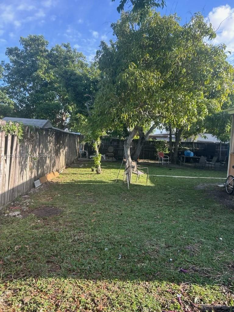 A kitchen features gray cabinets, white countertops, a tiled floor, and a white refrigerator — 19920 SW 118th Pl # 0, Miami FL 33177, MIAMI, FL